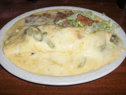 Burrito with green chile con queso sauce